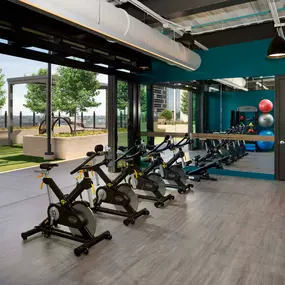 Fitness center spin studio with doors to the relaxation courtyard