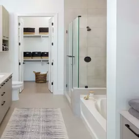 Warm modern finishes bathroom with soaking tub and stand up shower