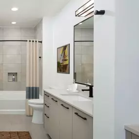 Warm modern finishes bathroom with quartz countertops and soaking tub