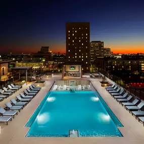 Swimming pool at dusk with fire pit and grills