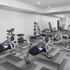 Separate spin and yoga room with spin bikes and strength equipment at Camden Design District apartments in Dallas, TX