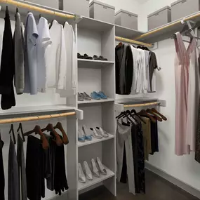 Spacious walk-in closet with concrete floors and built-in wood shelves at Camden Design District