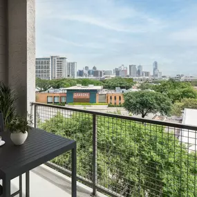 Private balcony overlooking Downtown Dallas skyline at Camden Design District apartments in Dallas, TX