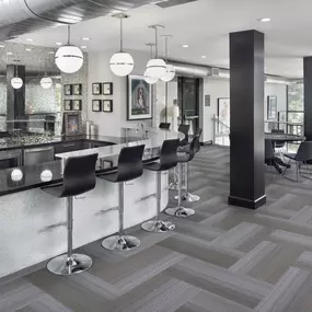 Resident lounge with kitchen and bar top at Camden Design District apartments in Dallas, TX