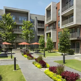 Lush courtyard with grills and seating at Camden Design District apartments in Dallas, TX