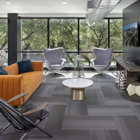 Resident lounge with seating and TV at Camden Design District apartments in Dallas, TX