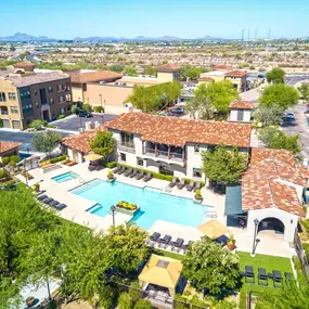 Aerial view of community pool surrounded by lush landscaping