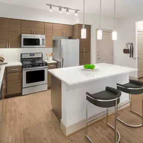 Camden Foothills Apartments Scottsdale AZ open concept kitchen with stainless steel appliances and island