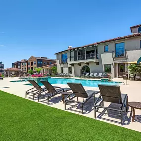 Resort style swimming pool with grass and sundeck