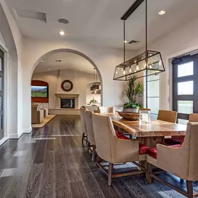 Resident clubhouse dining area with light fixture and wood style flooring