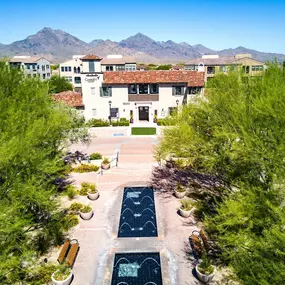 Aerial view of landscaped grounds with water fountains and camelback mountains in background