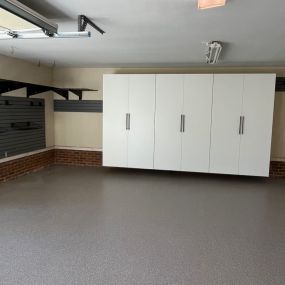 Garage in Laurens, SC.  Deep custom cabinets, Blackburn epoxy decorative flake flooring, grid shelving, and slatwall round out this installation.