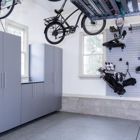 Premier One epoxy flooring, cabinets, slatwall and overhead storage complete this garage organization makeover.