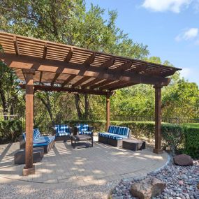 Poolside covered seating area at Camden Legacy Creek apartments in Plano, TX