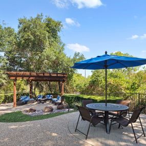 Poolside covered patio and table at Camden Legacy Creek apartments in Plano, TX