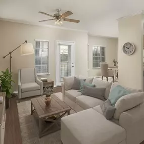 First-floor living room with wood-style flooring throughout and a private patio at Camden Legacy Creek