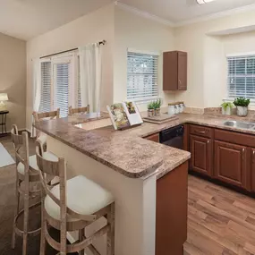 Kitchen with window and living room with carpet and balcony