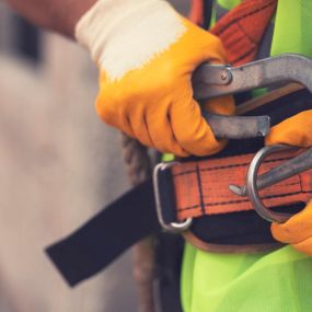 Worker attaching safety harness