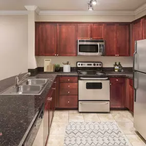 Kitchen with stainless steel appliances at Camden Northpointe Apartments in Tomball, TX