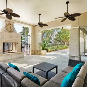 Exterior fireplace with lounge seating at Camden Northpointe Apartments in Tomball, TX