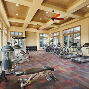 Fitness center with cardio equipment and free weights at Camden Northpointe Apartments in Tomball, TX