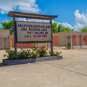 The sign in front of the office at Able Self Storage in Pearland, TX reminds customers that they can pay online 24/7 or give us a call to pay by phone.