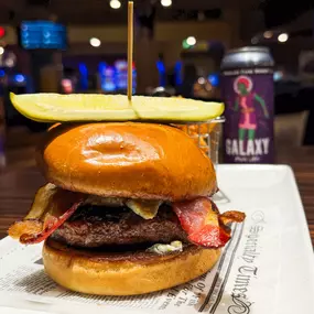 Bacon Blue Burger: Juicy beef patty topped with bacon, mushrooms, and blue cheese crumbles on a golden toasted brioche bun.