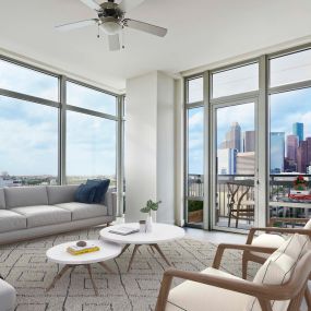Living room with floor to ceiling windows and downtown views