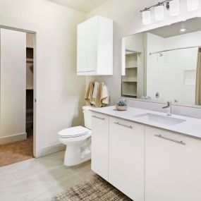 Bathroom with quartz countertops and walk in closet