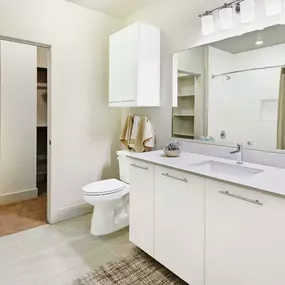 Bathroom with quartz countertops and walk in closet