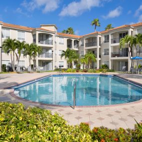 Pool overlooking marina with expansive deck space and lounging areas at Camden Aventura apartments in Aventura, Florida.