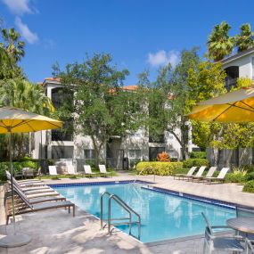 Swimming pool and seating areas at Camden Aventura apartments in Aventura, Florida.