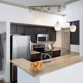 Kitchen with stainless steel appliances at Camden Aventura apartments in Aventura, FL