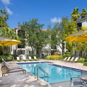 Swimming pool and seating areas at Camden Aventura apartments in Aventura, Florida.