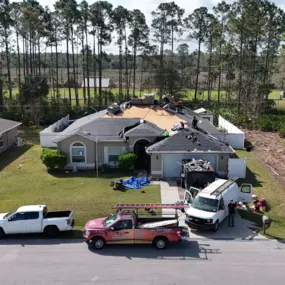 Noland's Roofing team replacing shingles on a home in Bradenton, Florida, highlighting roof deck preparation and professional crew at work.