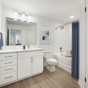 Renovated bathroom with white quartz countertops and white cabinets at Camden Stoneleigh apartments in Austin, Tx