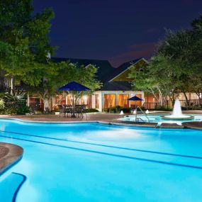 View of resort style swimming pool with lap lanes at night