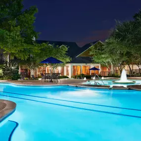 View of resort style swimming pool with lap lanes at night