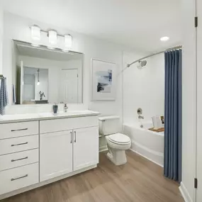 Renovated bathroom with white quartz countertops and white cabinets at Camden Stoneleigh apartments in Austin, Tx