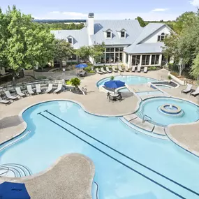 Aerial view of resort-style pool with swim lane and various seating spaces at Camden Stoneleigh apartments in Austin, TX