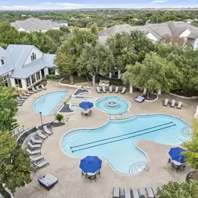 Aerial view of resort-style pool and deck behind the clubhouse at Camden Stoneleigh apartments in Austin, TX