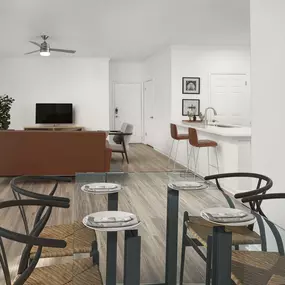 Dining room with built-in shelves and private balcony access overlooking living room and kitchen with wood-style flooring throughout at Camden Stoneleigh apartments in Austin, TX.