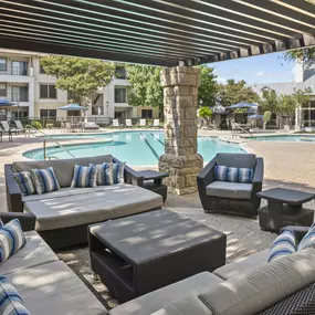 Poolside covered seating lounge at Camden Stoneleigh apartments in Austin, TX