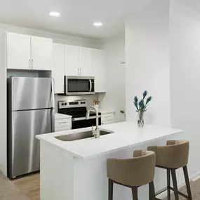 Kitchen with white countertops and white cabinets at Camden Stoneleigh apartments in Austin, Tx