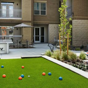 Outdoor game courtyard at Camden Lincoln Station Apartments in Lone Tree, CO
