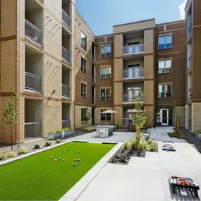 Courtyard outdoor games at Camden Lincoln Station Apartments in Lone Tree, CO