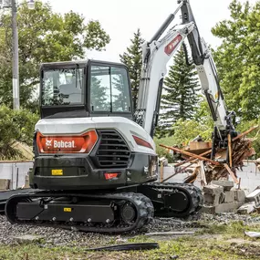 Bobcat E60 compact excavator performing demolition