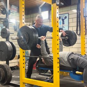 After training for a few months, Rich got a 1-rep max of 215 lb on the Bench Press.