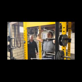 Jason, 37, attempting Shoulder Presses a heavy set of 5 repetitions with 155lbs. Jason has been a personal training  client for the last 10 months