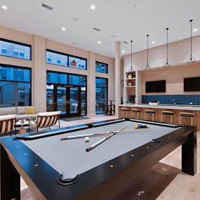 Club room with lounge seating, billiards, and a demo kitchen at The Huntington luxury apartments in Duarte, CA